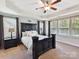 Elegant main bedroom featuring trey ceiling, ceiling fan, plush carpet, and abundant natural light at 16404 Mckee Ridge Dr, Charlotte, NC 28278