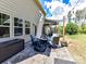 Relaxing patio area with stone flooring, outdoor seating, lighting and a partially covered patio at 16404 Mckee Ridge Dr, Charlotte, NC 28278