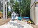 Delightful backyard playhouse with blue trim, a slide, a sandbox, and play equipment at 16404 Mckee Ridge Dr, Charlotte, NC 28278