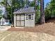 Charming backyard shed with a gray roof and weathered wood exterior, perfect for storage at 16404 Mckee Ridge Dr, Charlotte, NC 28278