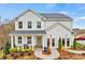 Beautiful two-story home featuring a modern facade, covered porch, and lush landscaping at 18010 Aura Mist Way # 178, Huntersville, NC 28078
