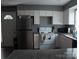 Functional kitchen with stainless steel refrigerator and white cabinets, offering ample storage space at 1906 Bromwich Rd # B, Charlotte, NC 28208