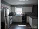 Well-lit kitchen featuring white cabinets and essential appliances for convenient meal preparation at 1906 Bromwich Rd # B, Charlotte, NC 28208