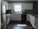 Well-appointed kitchen featuring white cabinets, appliances, and convenient workspace at 1906 Bromwich Rd # B, Charlotte, NC 28208