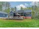 Landscaped backyard with a stone patio and screened-in porch at 2125 Partridge Berry Ln, Rock Hill, SC 29730