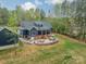 Expansive backyard featuring a stone patio with seating areas and lush landscaping at 2125 Partridge Berry Ln, Rock Hill, SC 29730