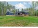 Spacious backyard featuring a patio, screened-in porch, and lush lawn at 2125 Partridge Berry Ln, Rock Hill, SC 29730