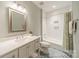 Well-lit bathroom with patterned tile floor, framed mirror, and tub with white subway tile at 2125 Partridge Berry Ln, Rock Hill, SC 29730