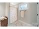 Bright bathroom includes a shower with an ornate curtain and marble floor at 2125 Partridge Berry Ln, Rock Hill, SC 29730