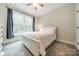 Bright bedroom features a large window offering natural light, ceiling fan, and neutral decor at 2125 Partridge Berry Ln, Rock Hill, SC 29730