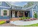 Charming covered porch with wood columns, shutters, seating, and landscaped entryway at 2125 Partridge Berry Ln, Rock Hill, SC 29730