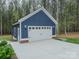 Detached garage featuring a brick foundation, carriage doors, and stylish lights at 2125 Partridge Berry Ln, Rock Hill, SC 29730
