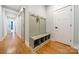 Hallway with wood floors, coat rack bench with storage, and stylish sliding doors at 2125 Partridge Berry Ln, Rock Hill, SC 29730