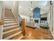 Bright living room showing stairs, fireplace, vaulted ceiling, and seamless flow to the kitchen at 2125 Partridge Berry Ln, Rock Hill, SC 29730