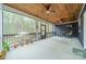 Relaxing screened porch with ceiling fans, comfortable seating, and views of the wooded backyard at 2125 Partridge Berry Ln, Rock Hill, SC 29730