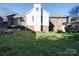 View of a backyard with a well-maintained lawn and a brick and white siding house at 2623 Shaw Ave, Gastonia, NC 28054