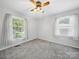 Bright bedroom with neutral gray carpet and windows providing natural light at 2623 Shaw Ave, Gastonia, NC 28054