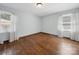 Inviting bedroom featuring hardwood floors and natural light from two windows at 2623 Shaw Ave, Gastonia, NC 28054