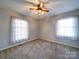 Bedroom with neutral walls, plush carpeting, and natural light offers a peaceful atmosphere at 2623 Shaw Ave, Gastonia, NC 28054