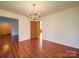 Open dining room with chandelier and wood floors, perfect for Gathering meals and entertaining guests at 2623 Shaw Ave, Gastonia, NC 28054