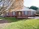 Charming brick home features mature trees, a well-maintained lawn, and a convenient front entry ramp at 2623 Shaw Ave, Gastonia, NC 28054