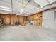 Spacious garage with concrete floor, workbench, and storage at 2623 Shaw Ave, Gastonia, NC 28054