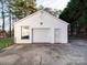 Exterior shot of a white detached garage with a concrete driveway and green star at 2623 Shaw Ave, Gastonia, NC 28054