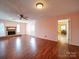 Bright living room features a cozy fireplace, wood floors, and access to the dining area and backyard at 2623 Shaw Ave, Gastonia, NC 28054