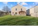 A spacious, fenced backyard features a well-kept lawn and covered patio area perfect for outdoor entertaining at 3428 Orr St, Charlotte, NC 28269