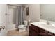 Full bathroom featuring a tiled floor, shower-tub, and vanity with dark wood cabinets at 3428 Orr St, Charlotte, NC 28269