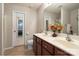 Bathroom showcasing a double sink vanity with dark wood cabinets and a large mirror at 3428 Orr St, Charlotte, NC 28269