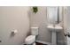 Bathroom featuring white toilet, pedestal sink, and chrome fixtures and hardware at 3428 Orr St, Charlotte, NC 28269