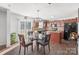 Bright eat-in kitchen featuring wood floors, stainless appliances, and sliding glass door to outdoor space at 3428 Orr St, Charlotte, NC 28269