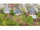 Aerial view showcasing the backyard with mature trees and a glimpse of a pool at 5125 Belicourt Dr, Charlotte, NC 28277