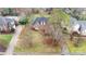 Aerial shot of a brick home featuring a pool, driveway, and beautifully landscaped yard at 5125 Belicourt Dr, Charlotte, NC 28277