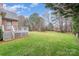 Expansive backyard with lush green grass, mature trees, and a deck perfect for outdoor enjoyment at 5125 Belicourt Dr, Charlotte, NC 28277