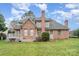Brick home featuring a well-maintained lawn, inviting deck, and mature landscaping for outdoor enjoyment at 5125 Belicourt Dr, Charlotte, NC 28277