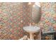 Charming powder room featuring ornate wallpaper and a pedestal sink at 5125 Belicourt Dr, Charlotte, NC 28277
