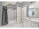 Neutral bathroom featuring a tub with shower, white cabinetry, and a large mirror at 5125 Belicourt Dr, Charlotte, NC 28277