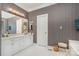 Stylish bathroom with patterned wallpaper, double sinks, and vanity for a luxurious feel at 5125 Belicourt Dr, Charlotte, NC 28277