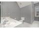 Stylish bathroom with striped wallpaper, a single sink vanity, and tiled floors at 5125 Belicourt Dr, Charlotte, NC 28277