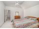 Bright bedroom with ceiling fan, soft carpet, and natural light from the hallway at 5125 Belicourt Dr, Charlotte, NC 28277