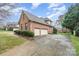 Stately brick home with a two-car garage, large driveway, and manicured landscaping at 5125 Belicourt Dr, Charlotte, NC 28277