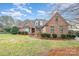 Beautiful brick home featuring manicured landscaping and a well-maintained lawn at 5125 Belicourt Dr, Charlotte, NC 28277
