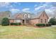 Well-maintained brick home with manicured lawn and shrubbery at 5125 Belicourt Dr, Charlotte, NC 28277