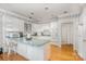 Spacious kitchen with a breakfast bar, white cabinetry, and hardwood flooring at 5125 Belicourt Dr, Charlotte, NC 28277
