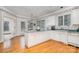 Bright kitchen with a center island, white cabinetry, and hardwood floors at 5125 Belicourt Dr, Charlotte, NC 28277
