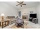 Comfortable living room with a fireplace and entertainment center at 5125 Belicourt Dr, Charlotte, NC 28277