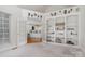 Bright room with bookshelves and French doors to the kitchen at 5125 Belicourt Dr, Charlotte, NC 28277