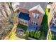 Aerial view of a home with a lush backyard, patio, mature trees, and a well-maintained lawn at 615 Bourton House Dr, Charlotte, NC 28211